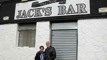 Outside Jack's Bar Marie and her husband standing outside
